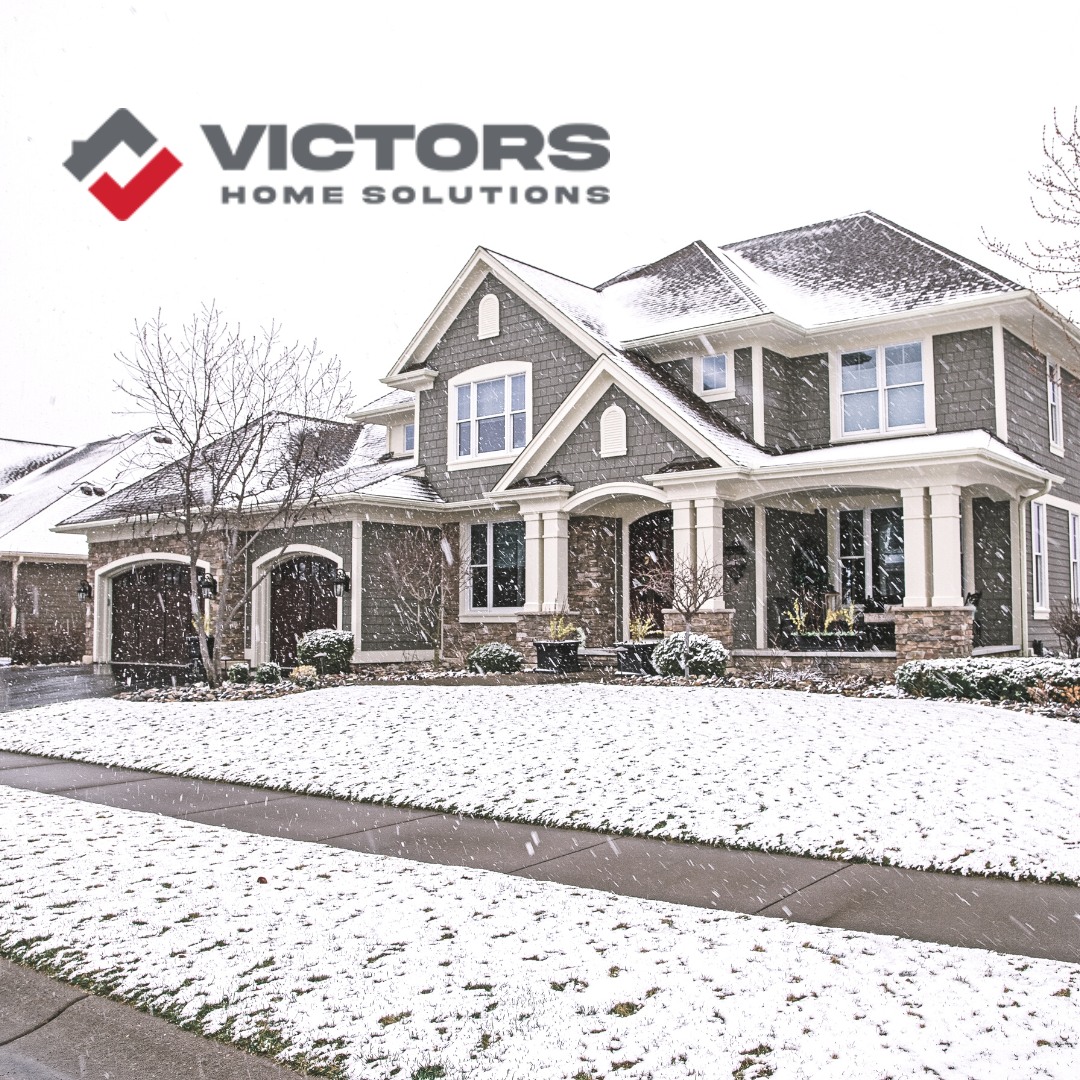 Home with three car garage and beautiful columns at the front door in Hudsonville, MI during a western michigan snowstorm.