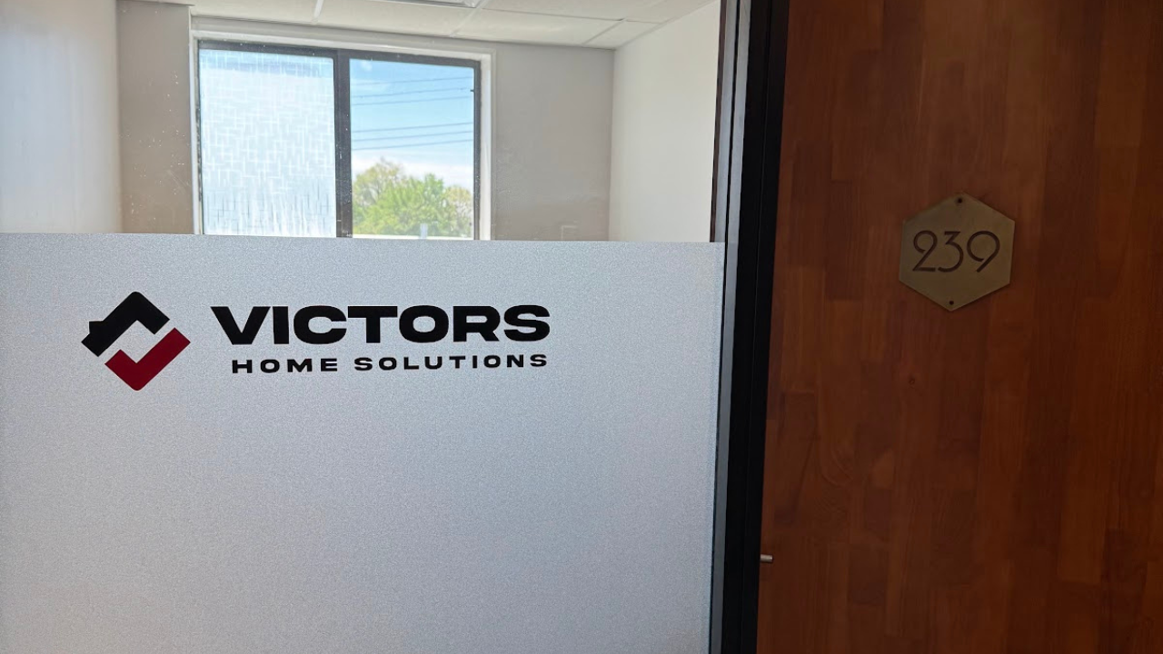 Office door with a frosted glass panel reads 